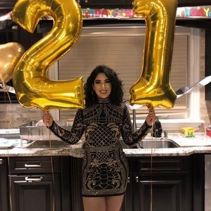Black, low-back dress with gold gems/sequins